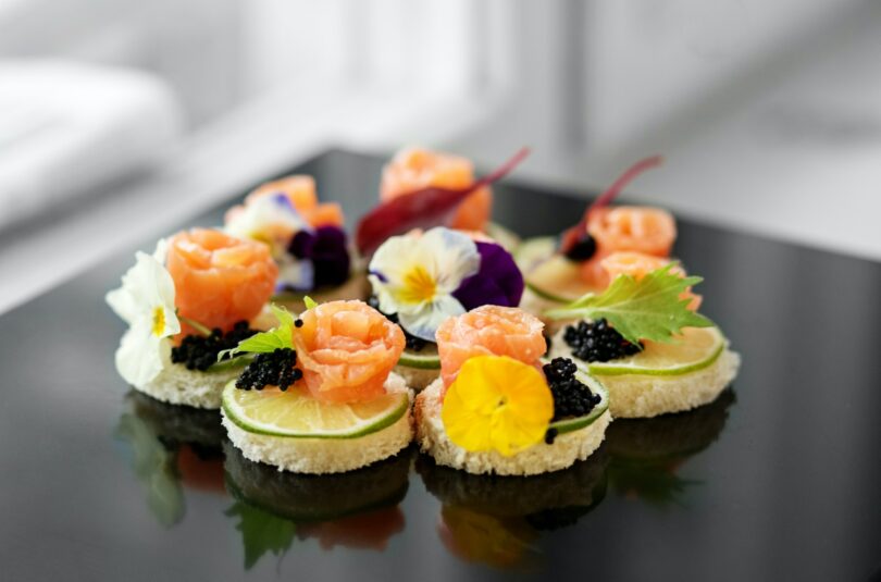Delicious appetizer with salmon and edible flowers. Concept for food, restaurant, menu, catering