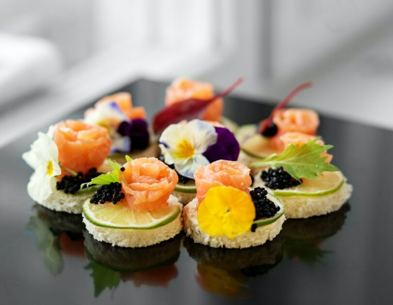 Delicious appetizer with salmon and edible flowers. Concept for food, restaurant, menu, catering